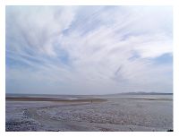 touching Dublin's bay low tide - the black point in the middle, a person walking and searching for sea-shells.